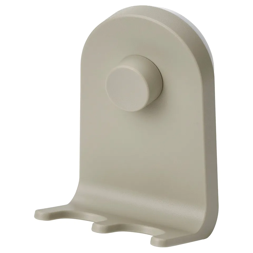 The ÖBONÄS wall organiser in a light beige colour, made of plastic, with a rounded design and suction cups for mounting.