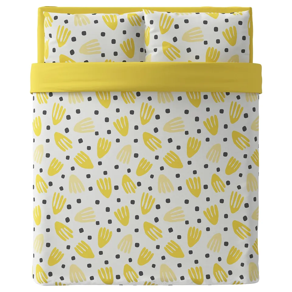 Bright yellow bed set with white background, hand prints, and black dots. Includes duvet cover and pillows.
