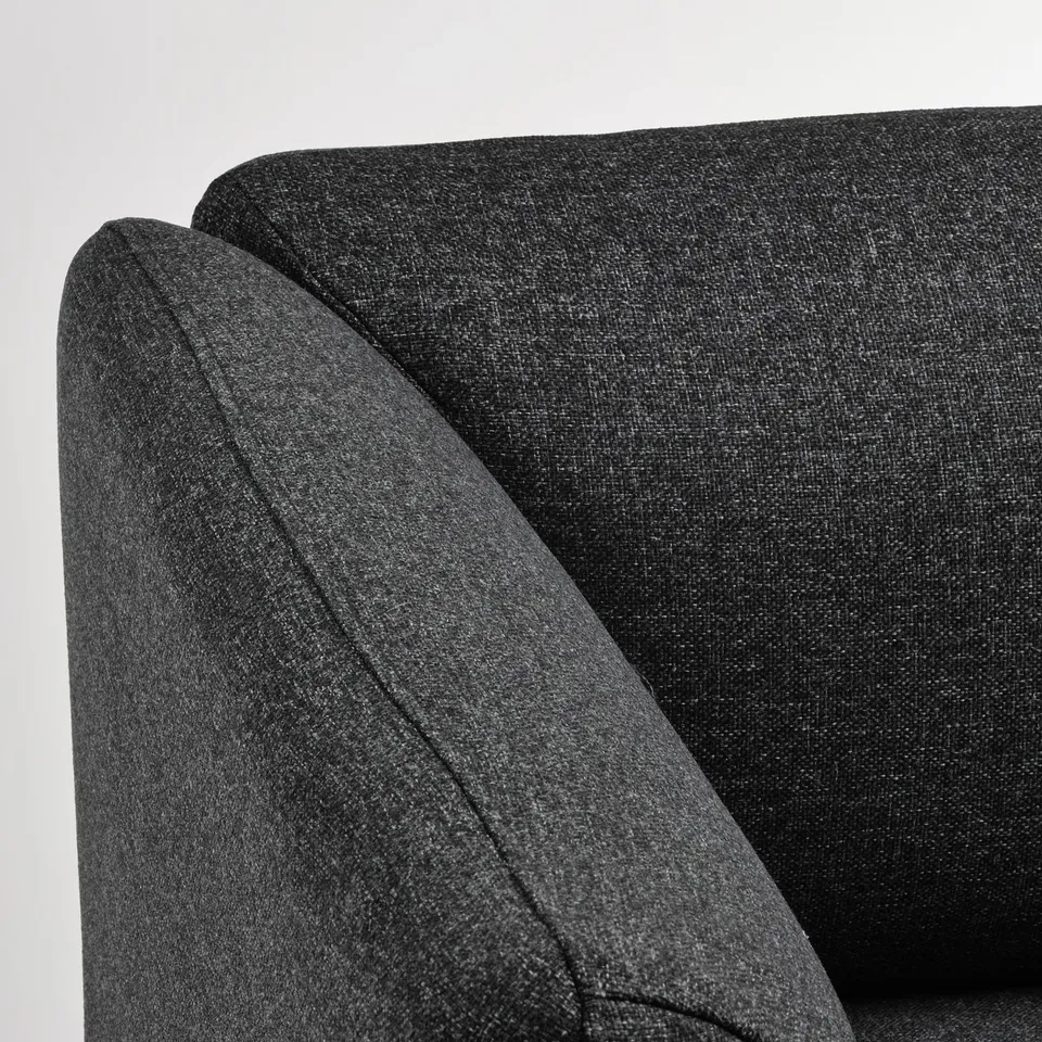 A plush, charcoal grey sofa with curved edges; soft, high-quality upholstery; inviting and comfortable.