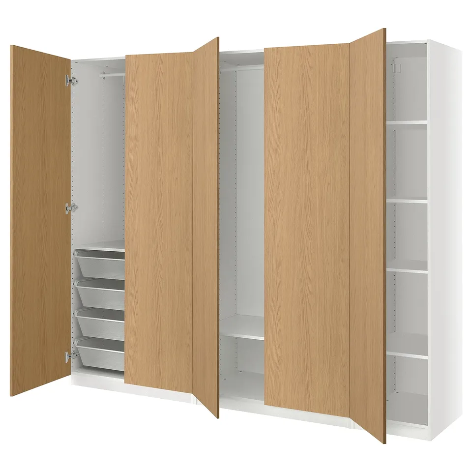 Light wood PAX wardrobe with white interiors. Adjustable shelves and mesh baskets.