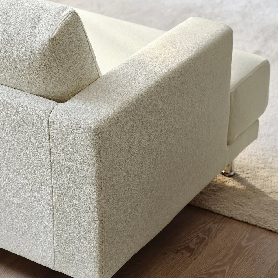 Modern sofa in neutral fabric, showcasing quality materials & clean design.