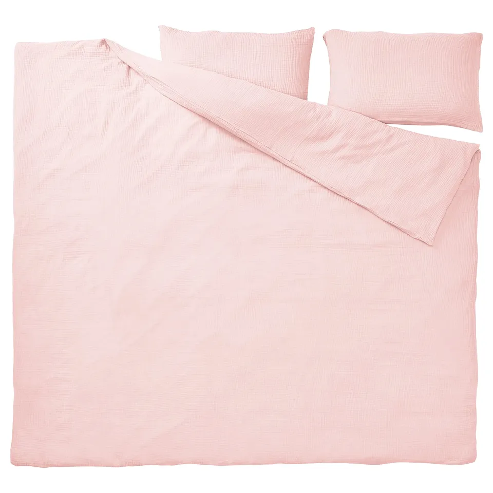 A SCHERSMIN duvet set in light pink, made of soft organic cotton, with a smooth, relaxed texture and an envelope-closure pillowcase.