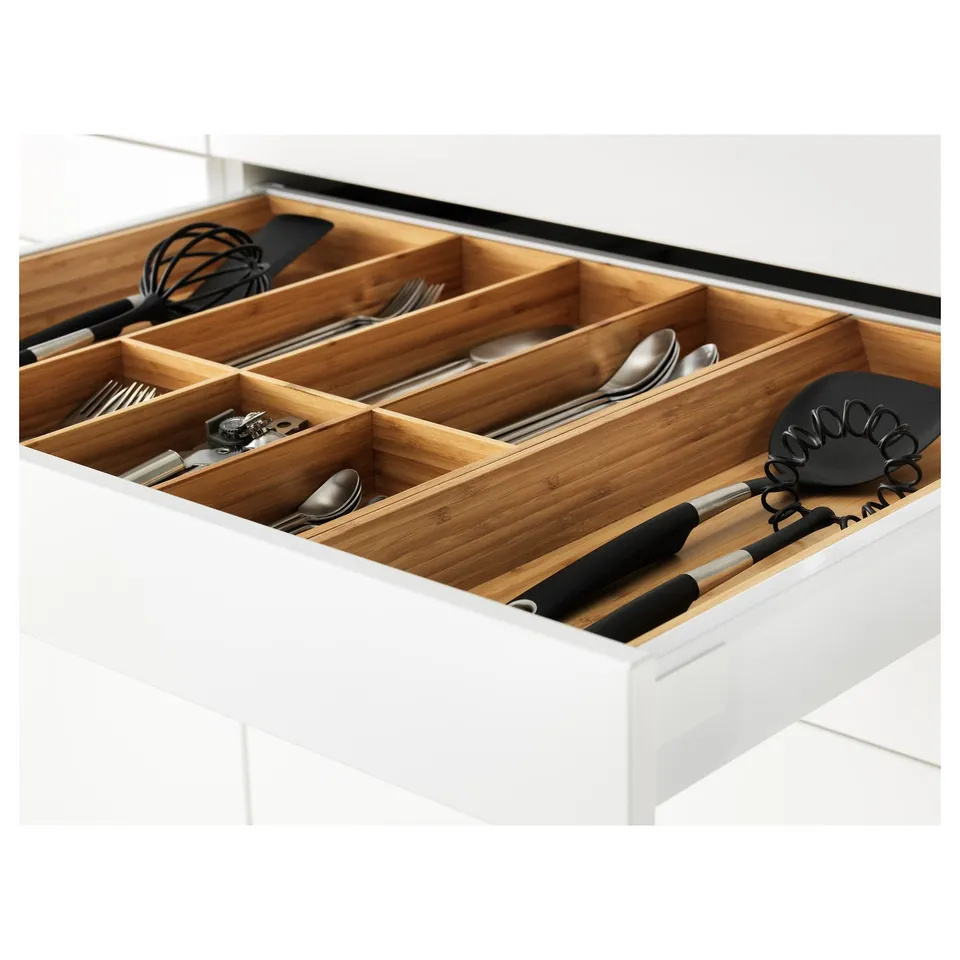 Organised kitchen drawer with wooden dividers holding various utensils.