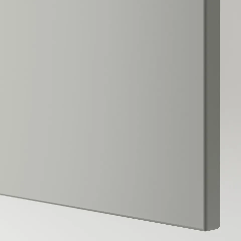 Close-up of sleek, modern grey kitchen cabinet door, smooth surface and clean edge.