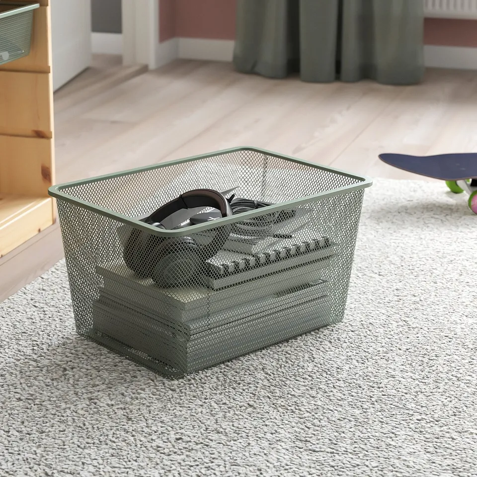 TROFAST basket with cables on carpet.