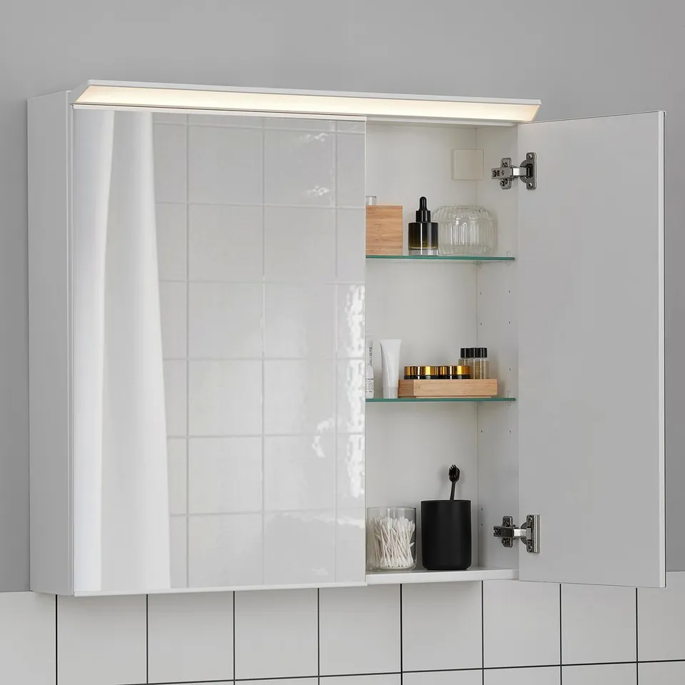 White mirror cabinet with led light; it stores toiletries, reflecting and illuminating the bathroom.