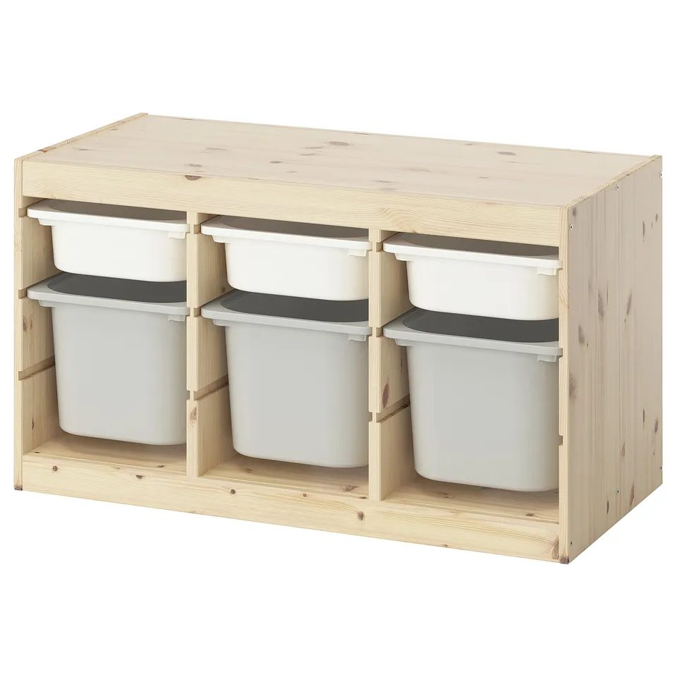 A TROFAST light wooden storage unit with white plastic bins. Its rectangular, designed for kids to organise toys.