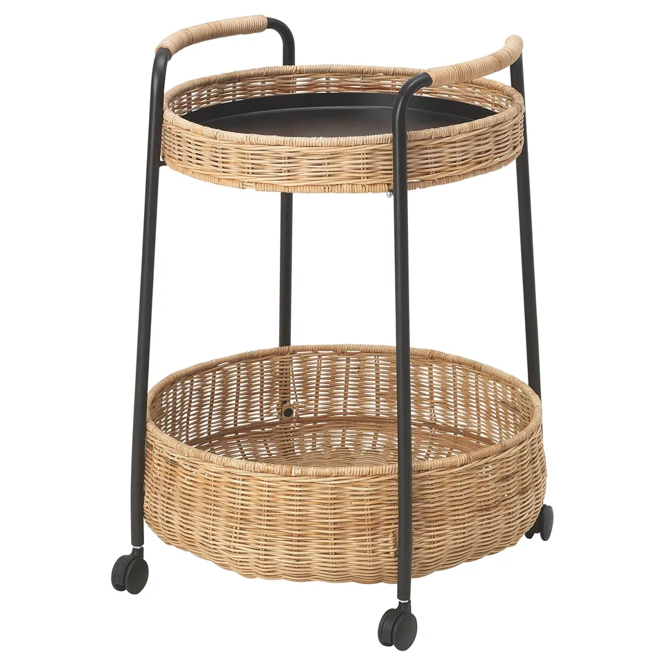 A LUBBAN two-tier rattan cart with black metal legs and wheels, designed for easy portability and natural aesthetic appeal.