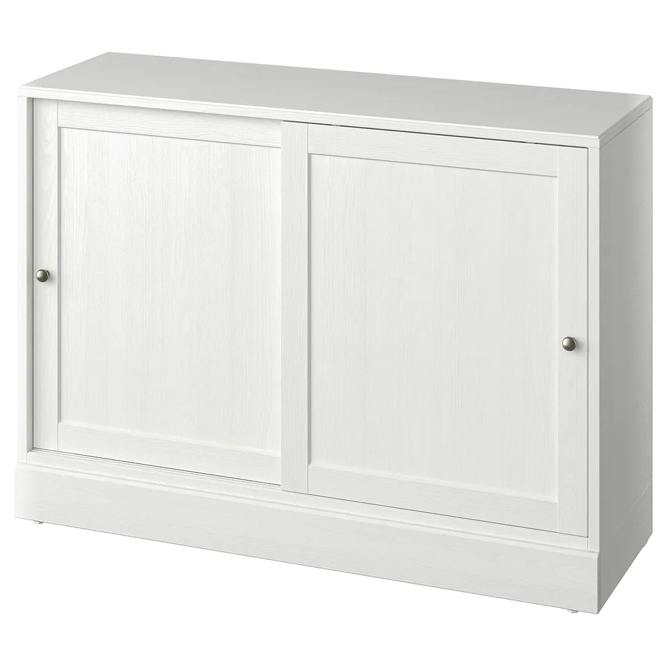 A white HAVSTA sideboard made from solid pine, featuring sliding doors and a rectangular design.