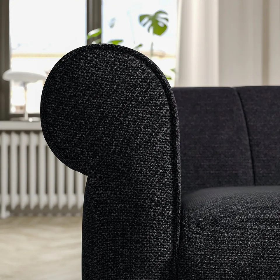 Black VISKAFORS sofa, rounded armrests, soft design.