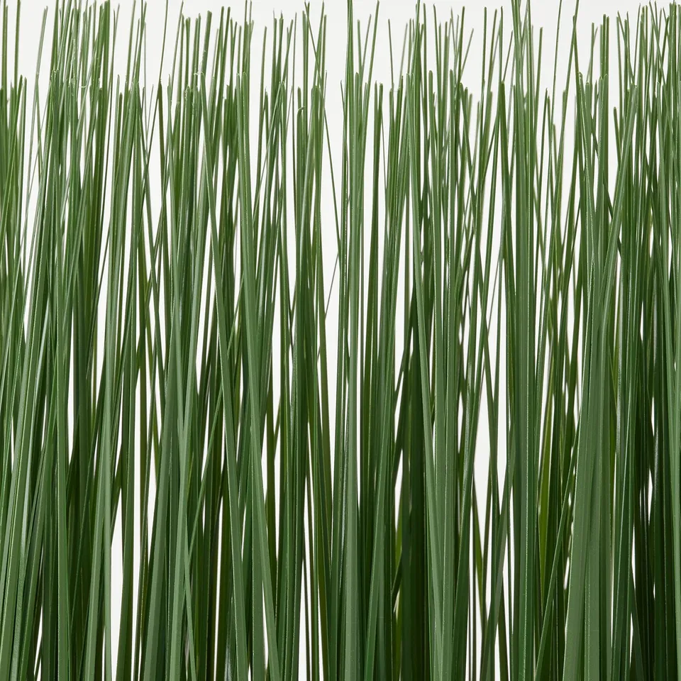 A bunch of lush, green artificial plants, meticulously crafted to resemble real foliage, displayed against a white background.