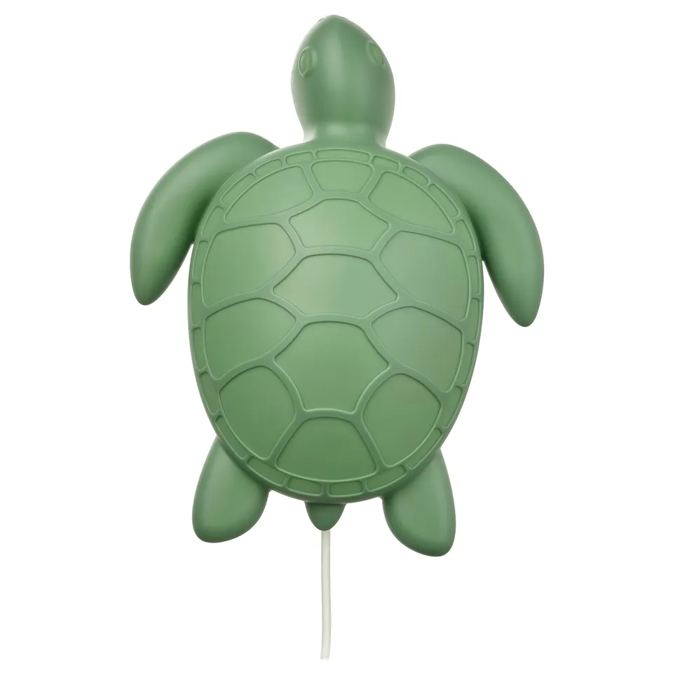 Green recycled plastic turtle wall light with soft glow.