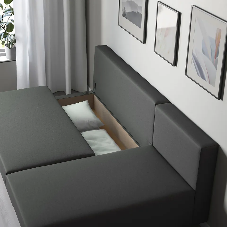 Modern sofa with hidden bed compartment, grey fabric, versatile chaise longue, neat design with storage.