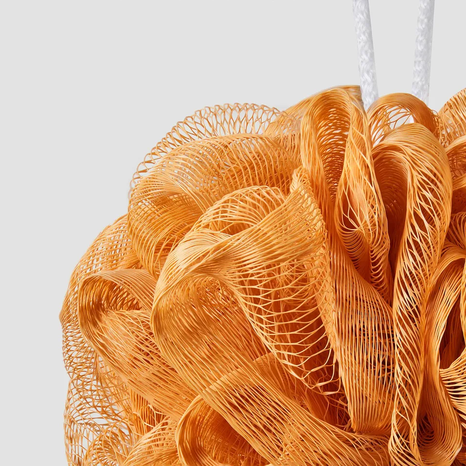 Orange mesh shower puff, hanging. Durable, with multiple loops for easy hanging.
