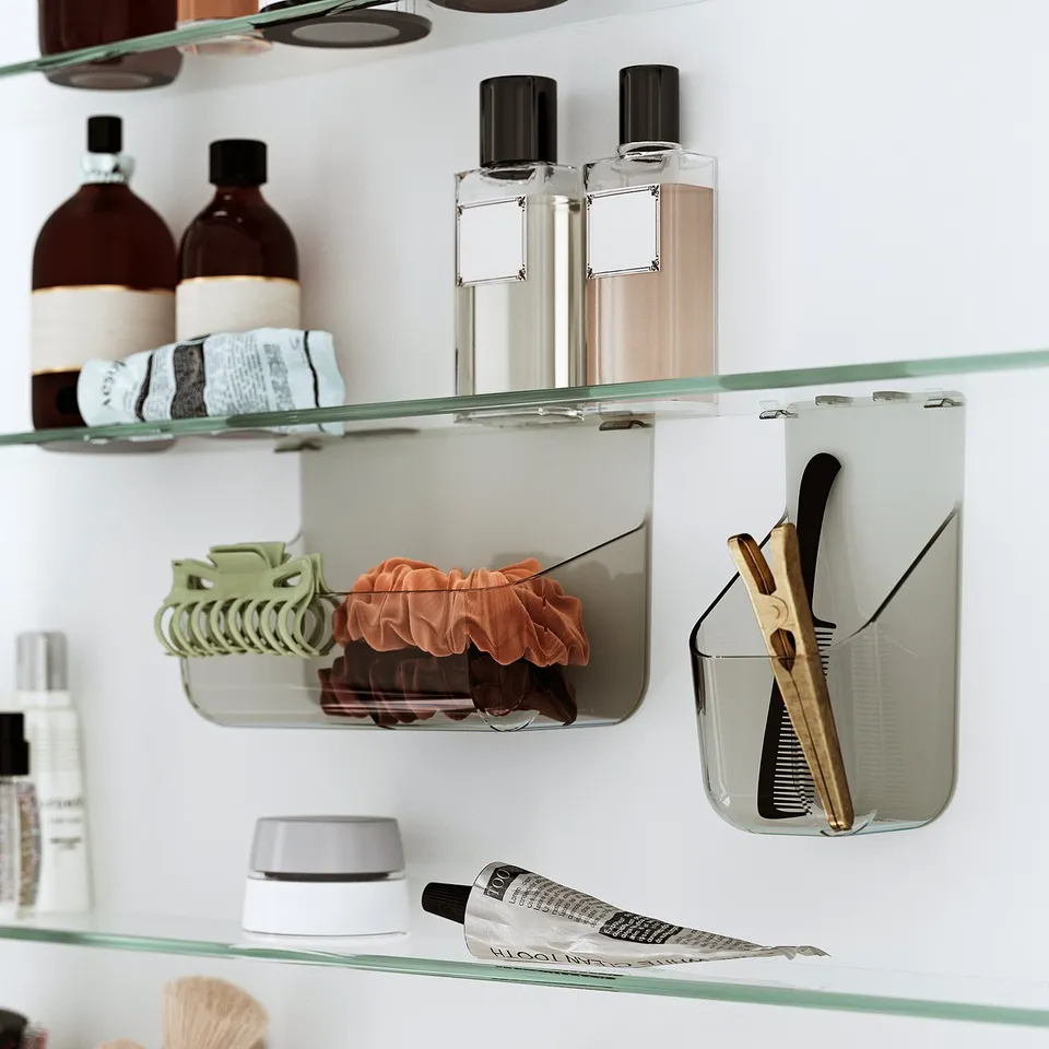 Glass bathroom shelves holding bottles, scrunchies, and hair tools.
