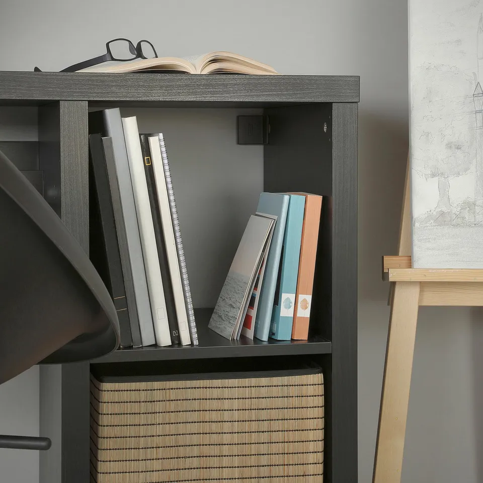 KALLAX desk with books and decor.