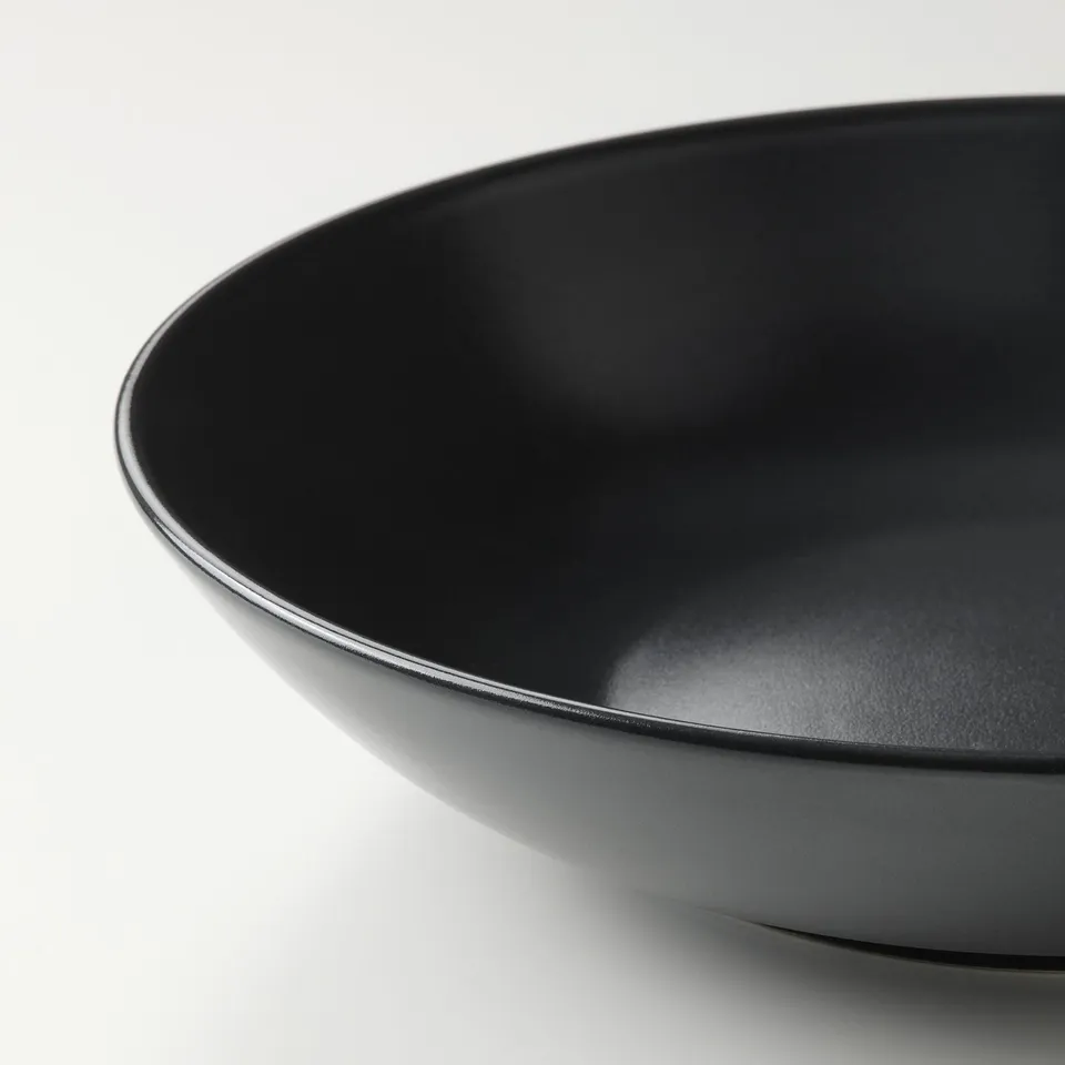 Sleek black bowl, smooth finish, deep round shape, elegant simple design.