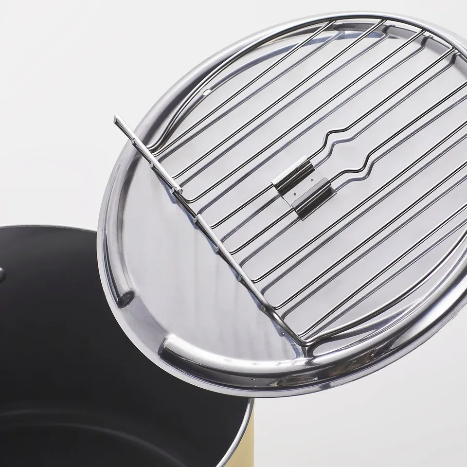 Stainless pot with metal rack, surely durable and practical.
