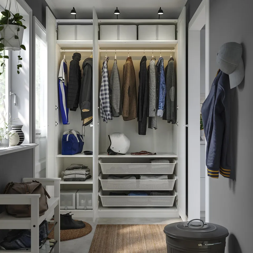 Organised closet with hangers, drawers, and storage bins for clothes and accessories.