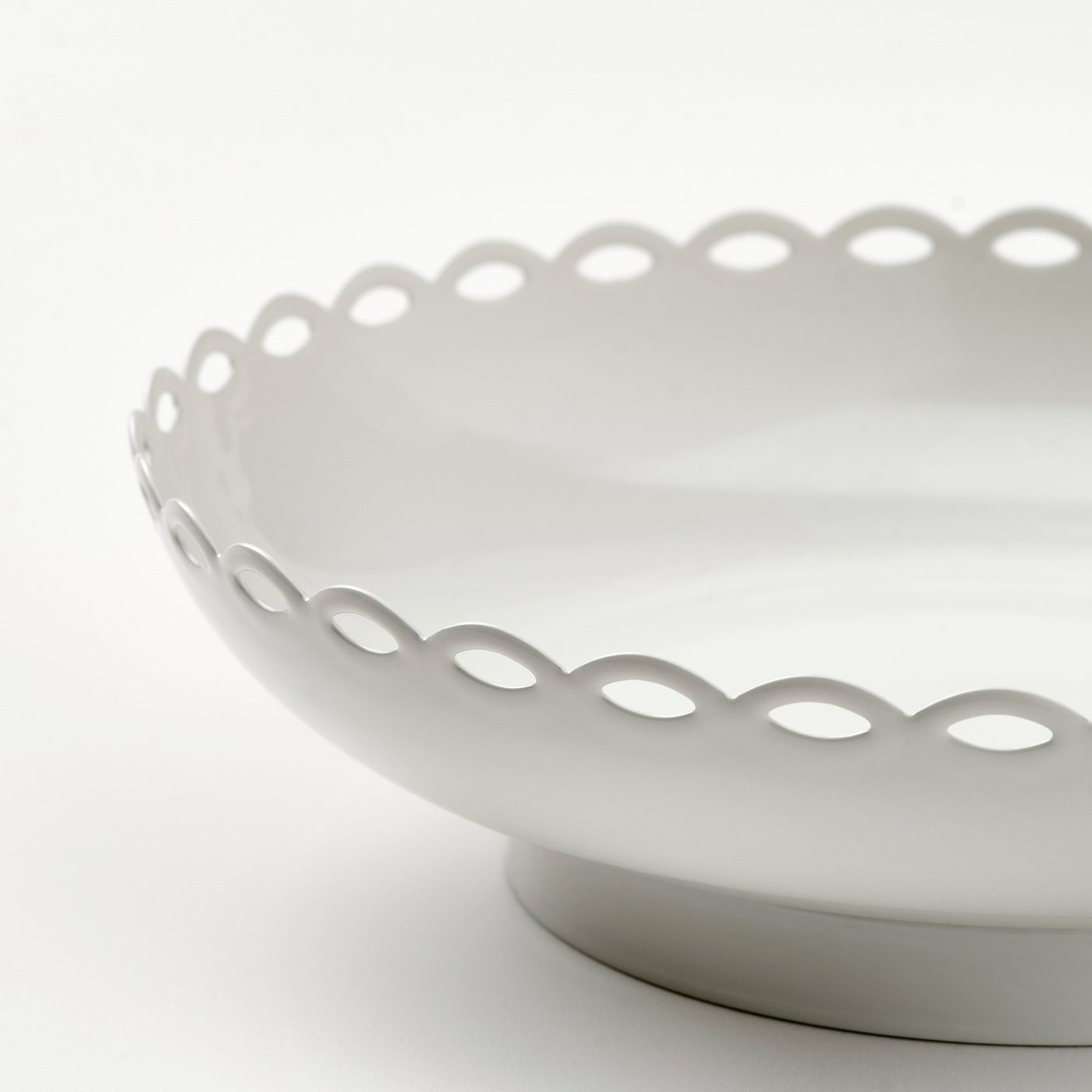 Elegant white candle holder with scalloped edge and smooth finish, showcasing timeless charm and vintage appeal.