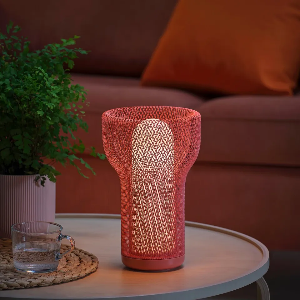 Modern lamp with interwoven mesh, warm soft light, indoor/outdoor use.