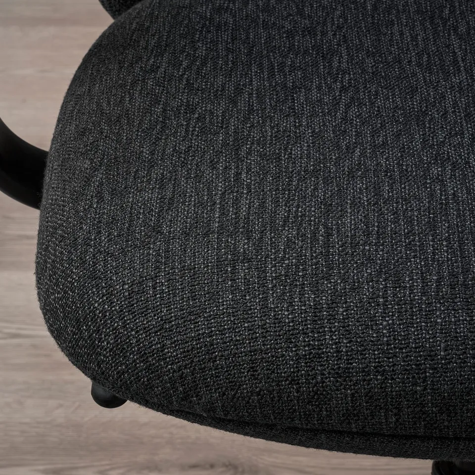 Close-up of ergonomic office chairs upholstered seat, showcasing textured fabric and sturdy base.