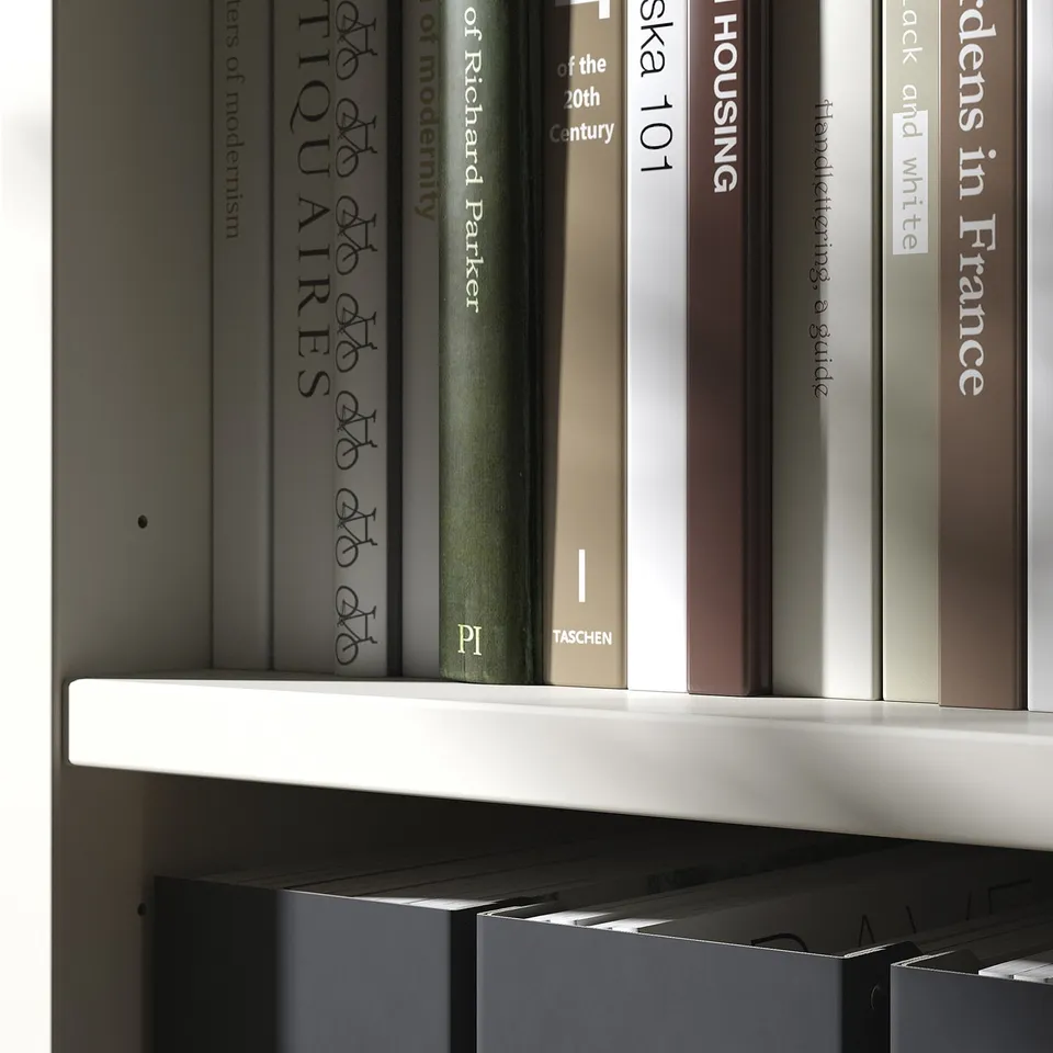 Bookshelf in off-white, TONSTAD series. Dense books on white shelves, neatly aligned. High-quality finish on modern furniture.