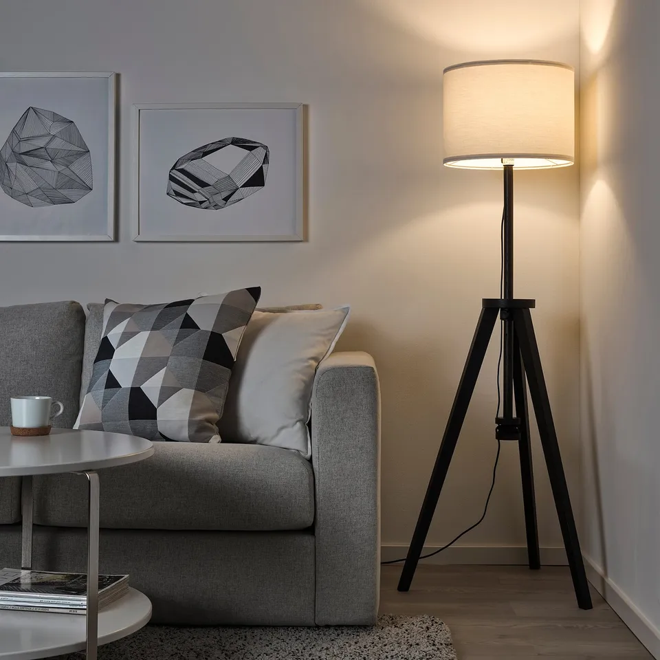 Modern living room with grey sofa, black lamp, LAUTERS, art.