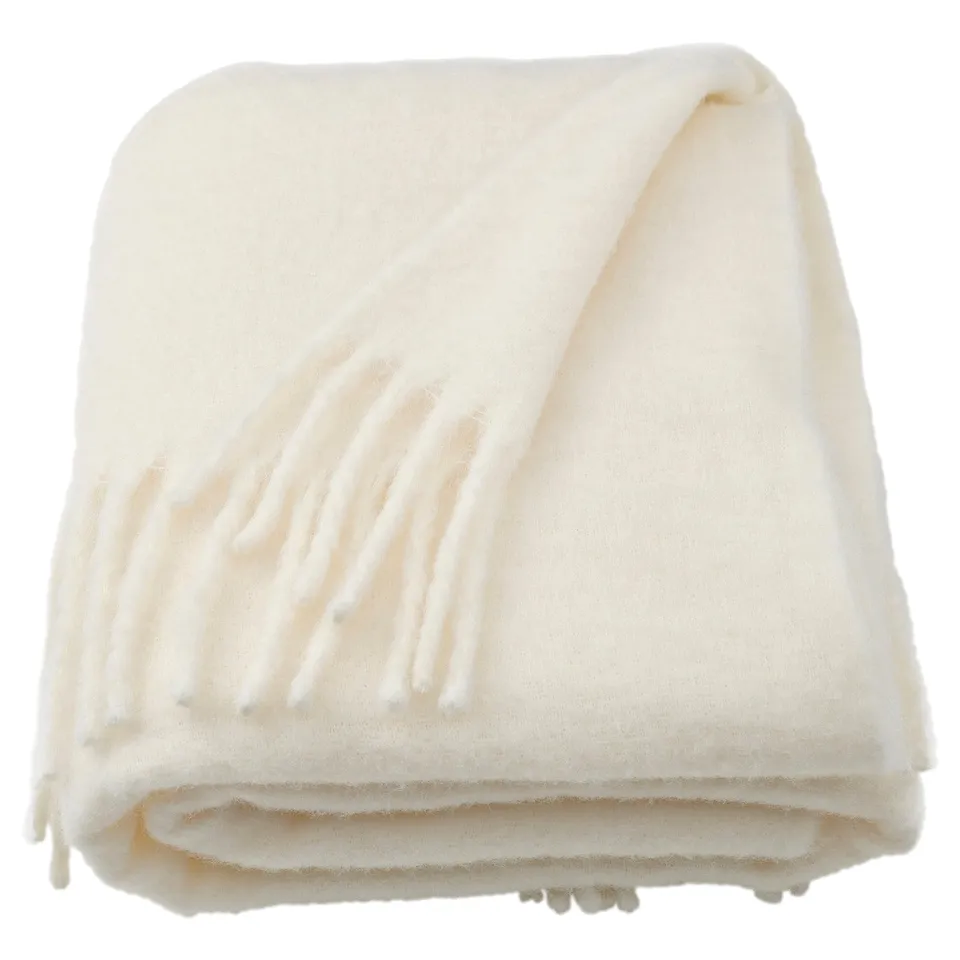 Folded off-white recycled polyester throw blanket with soft, fluffy texture.