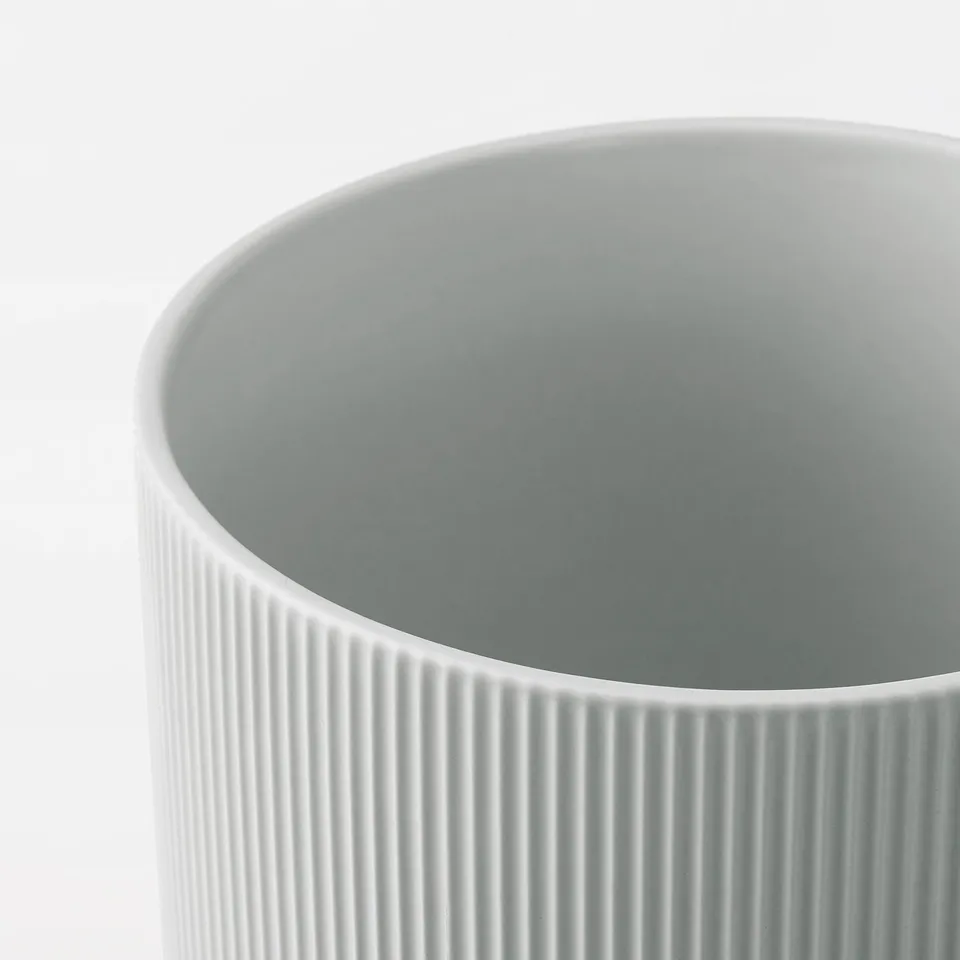 Smooth, cylindrical vase with vertical grooves, likely stoneware, showcasing refined craftsmanship and simple elegance.