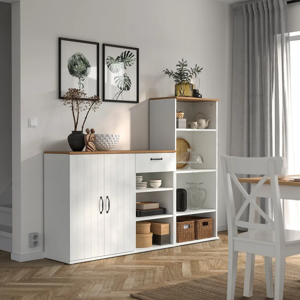 Modern dining area with SKRUVBY white sideboard and bookcase, traditional yet functional.
