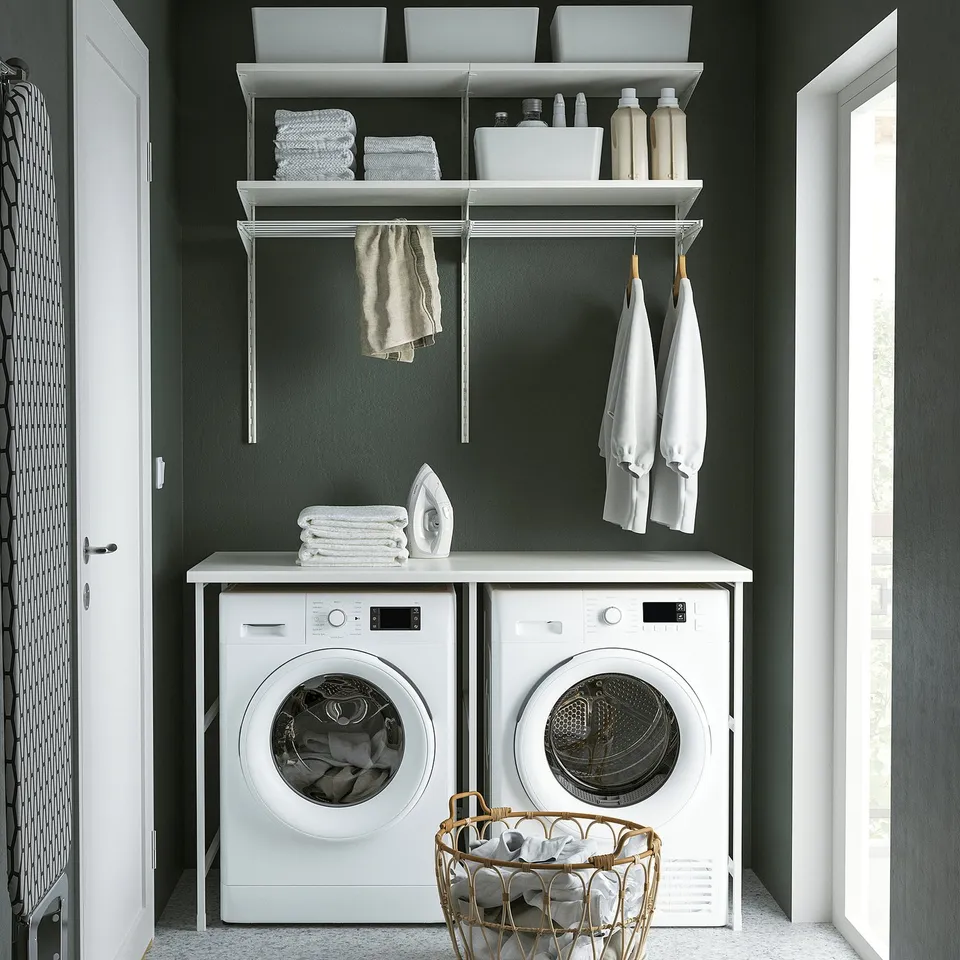Modern laundry room with white ENHET appliances, green walls, and organised shelves.