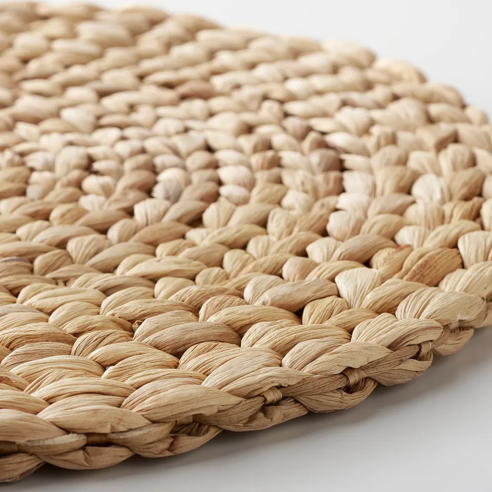 Handwoven water hyacinth placemat with intricate texture, showcasing natural fibres and craftsmanship.