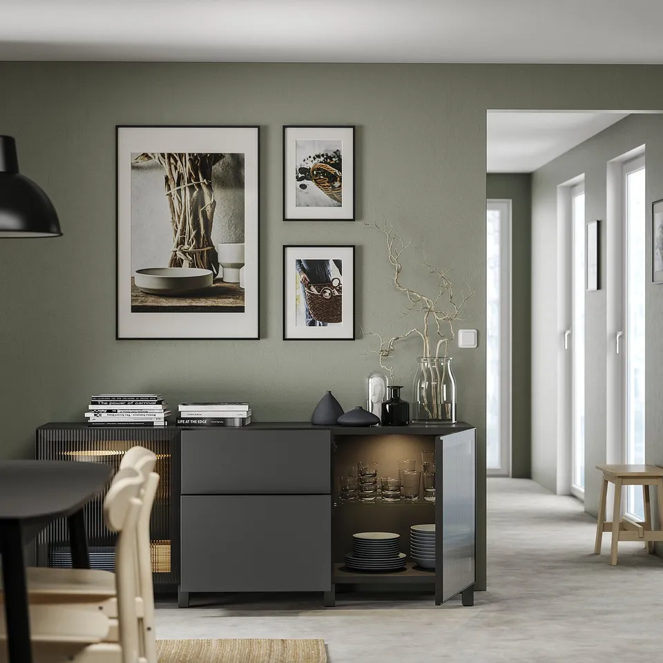 Modern living room with BESTÅ storage unit, green walls, and decor.