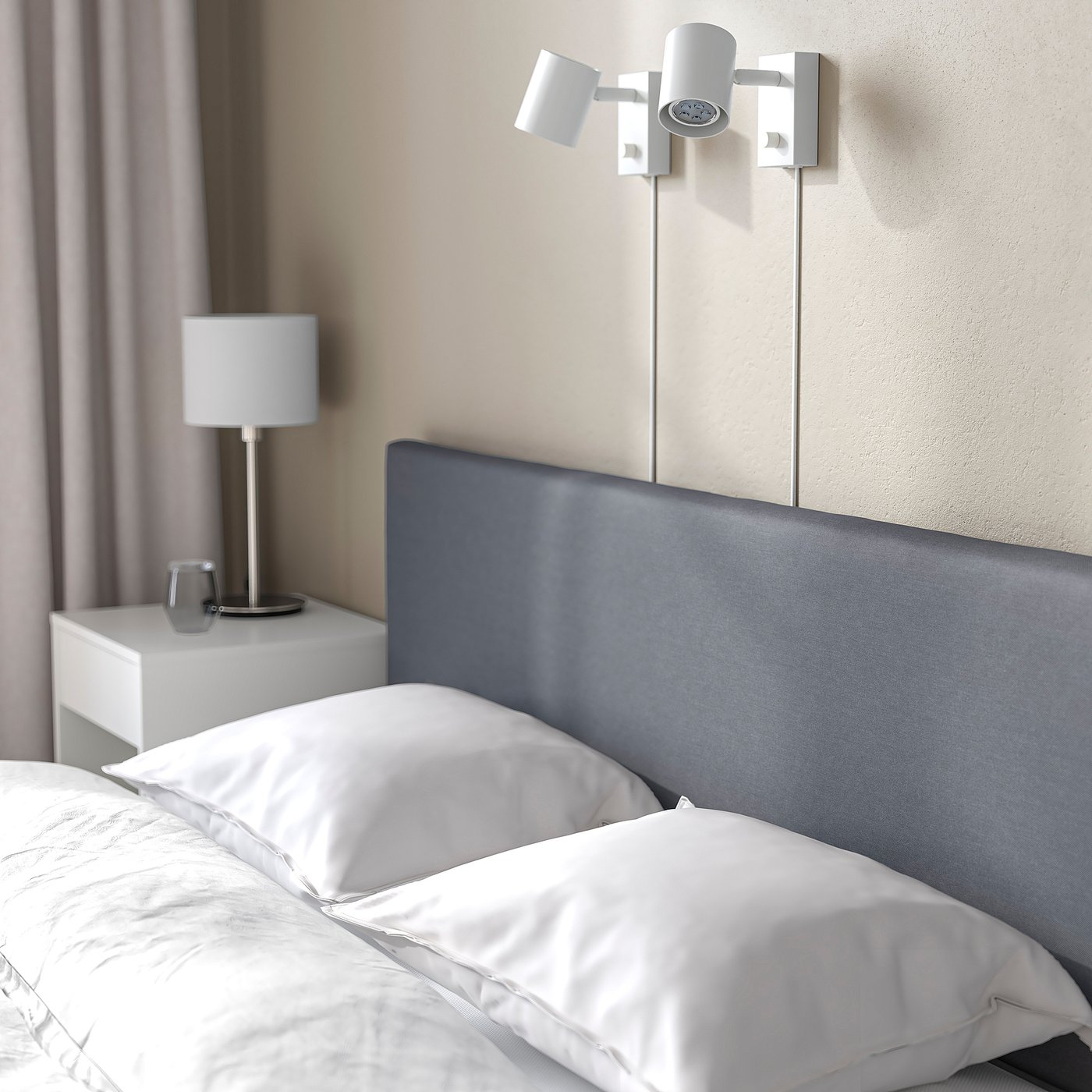 Minimalist bed with blue headboard, wall-mounted light, white linens, and bedside table with lamp.