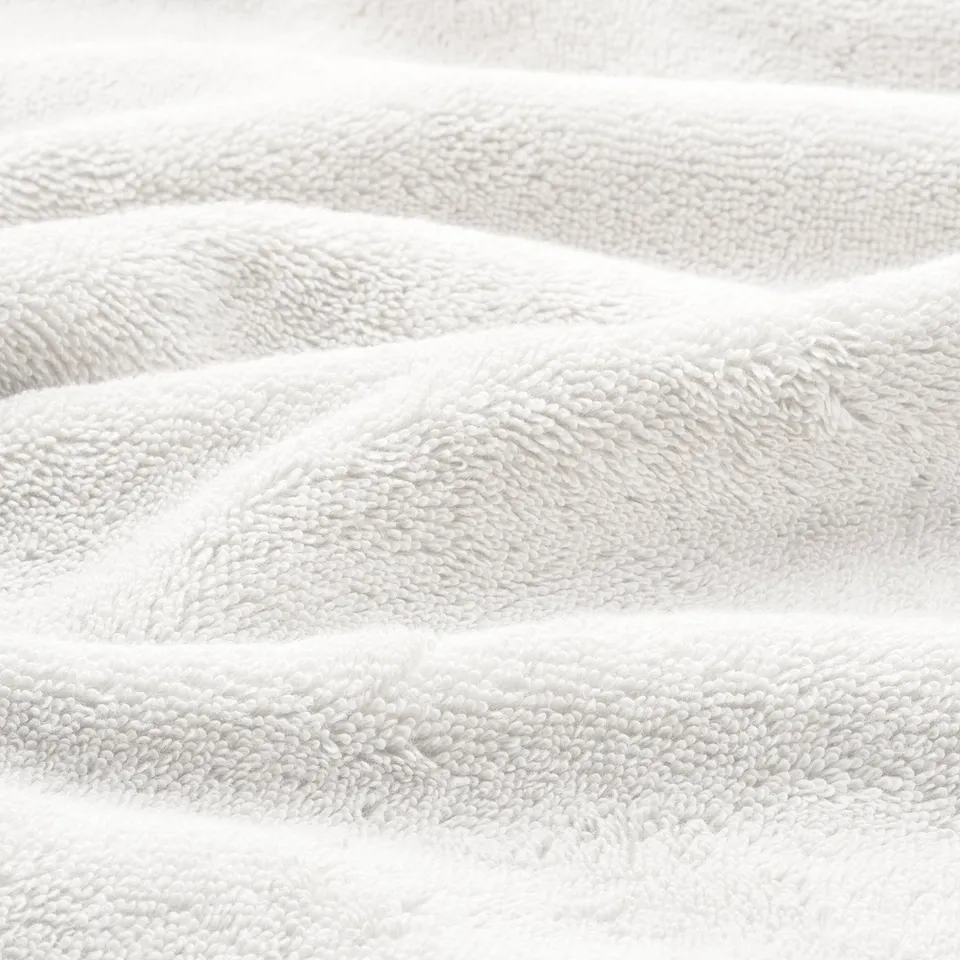 Close-up of soft, high-quality, organic cotton towels with a textured weave and elegant border.