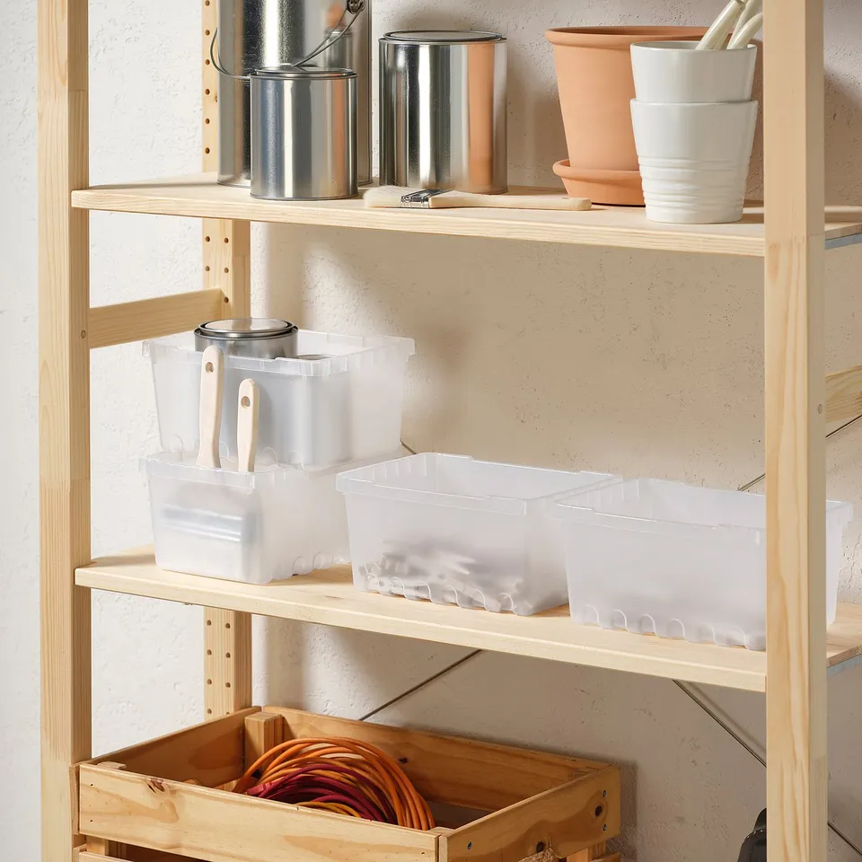 Wooden shelves with items: buckets, planter, cups, boxes, and coiled cords in crate.