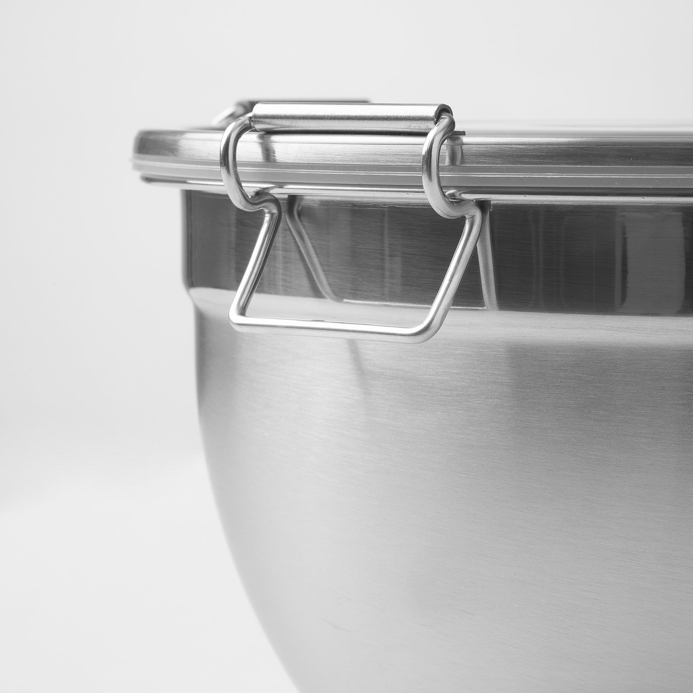 Silver stainless steel container with secure clasp and tight lid, perfect for storing food.