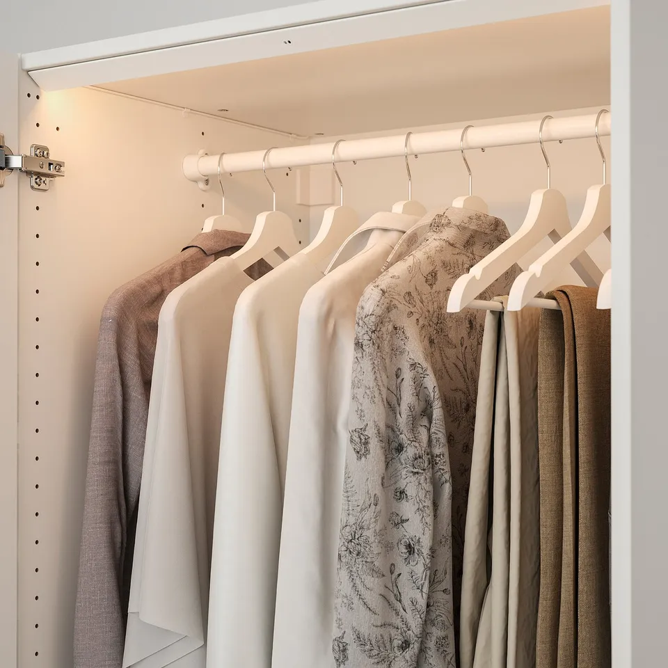 Led-lit closet with clothes.