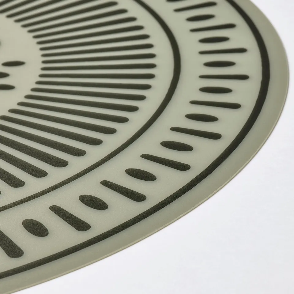 Two green place mats, one with horizontal lines, the other with vertical, both made of smooth plastic.