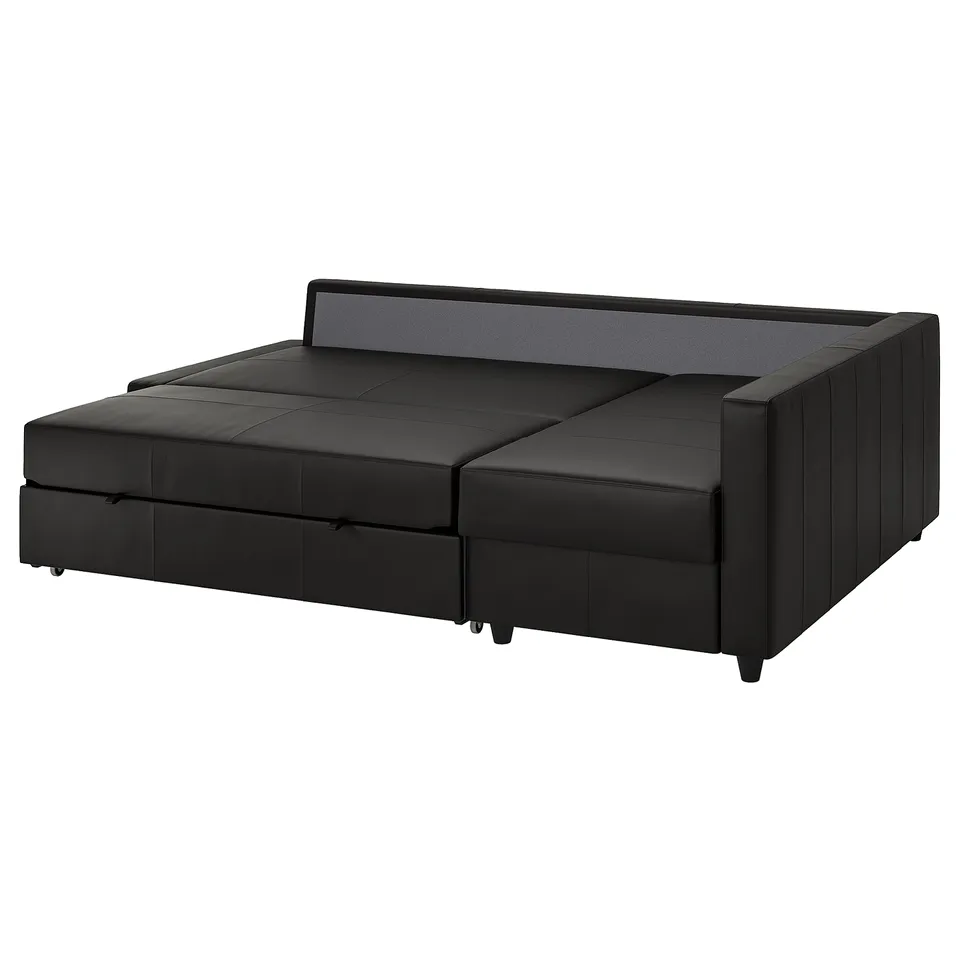 A black FRIHETEN sofa-bed with a convertible chaise longue and storage.