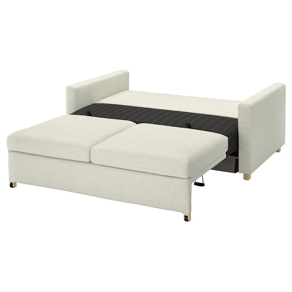 A light beige modular sofa, SALTSJÖBADEN, with a sleek design and wooden legs. It converts into a bed with a cushioned mattress.