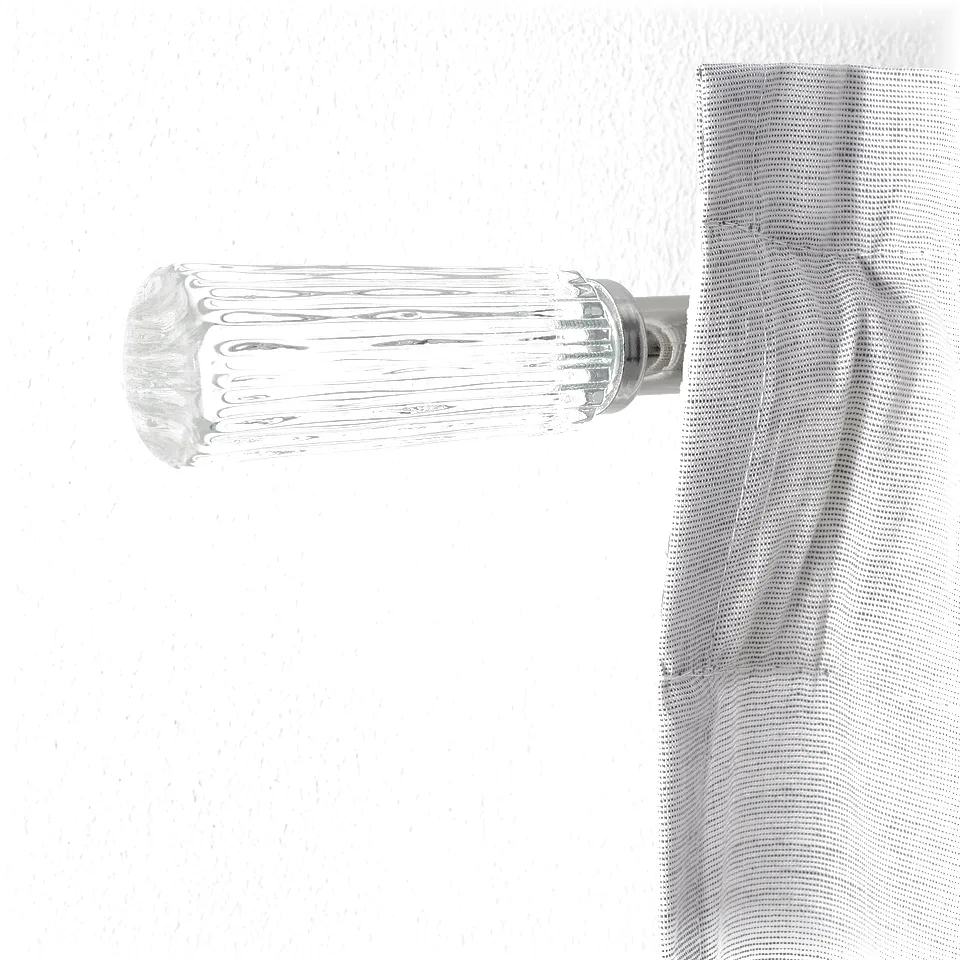 Modern wall-mounted curtain rod, polished chrome and clear glass finials, sleek design.