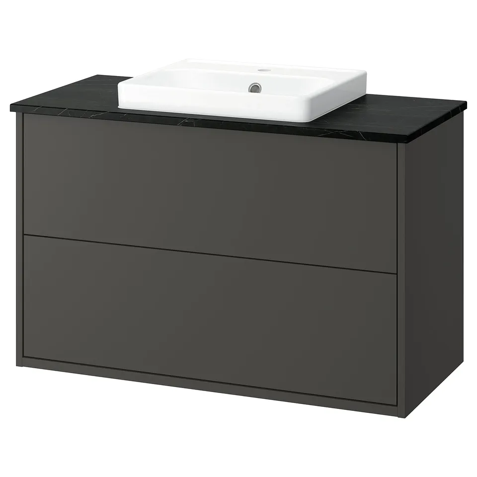 The HAVBÄCK washstand is sleek in dark grey with two drawers, a black countertop, and a white semi-recessed sink.