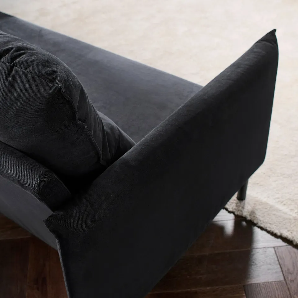 Dark grey sofa with clean lines and plush cushions, perfect for relaxing.