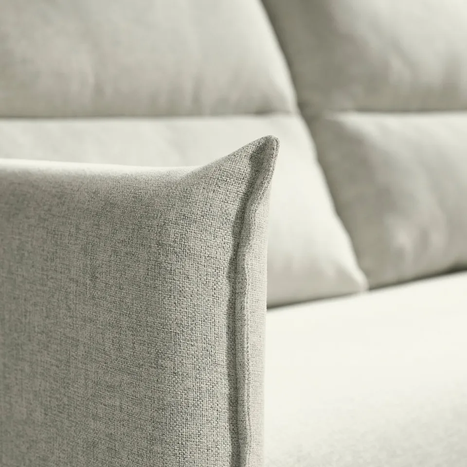 Close-up of soft, high-quality sofa cushion with clean lines and gentle folds, showcasing comfortable, inviting texture.