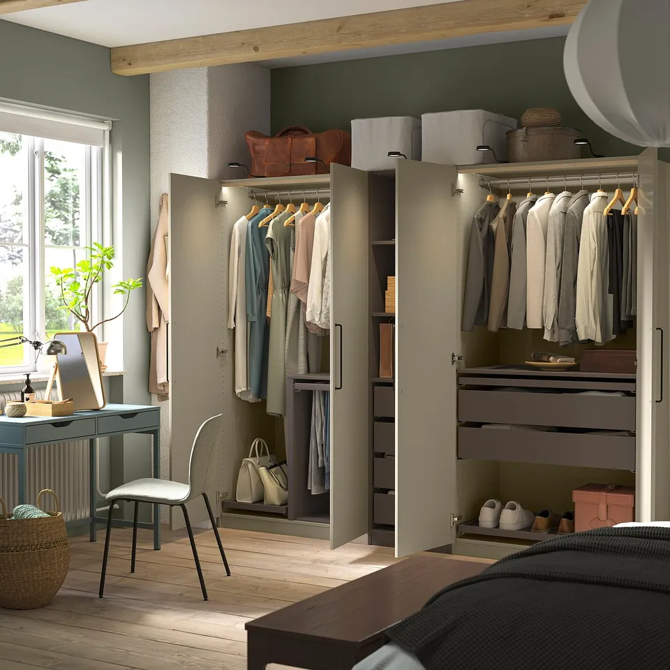 Walk-in closet with open and closed storage, lit interior.