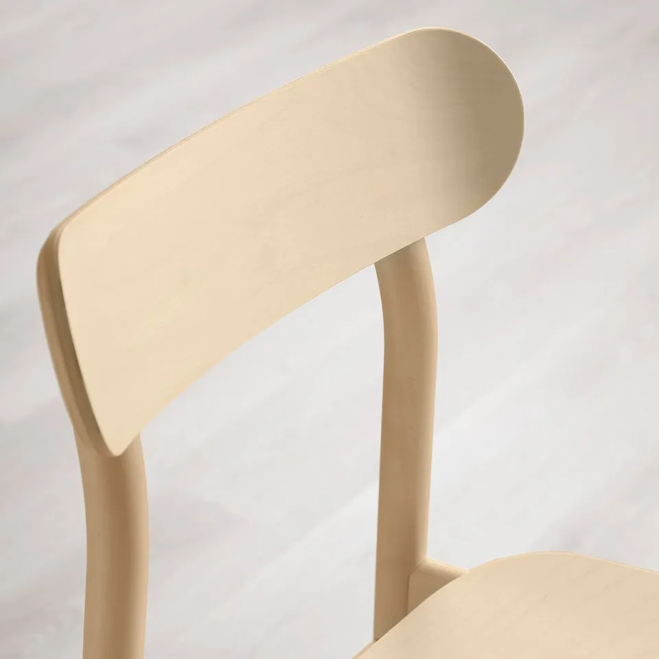 Modern chair backrest detail, smooth wood grain, light finish.