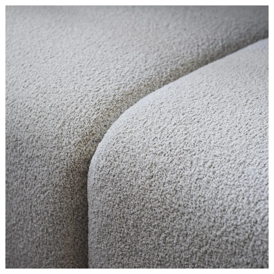 Close-up of cosy, textured sofa fabric; soft, durable, and inviting.