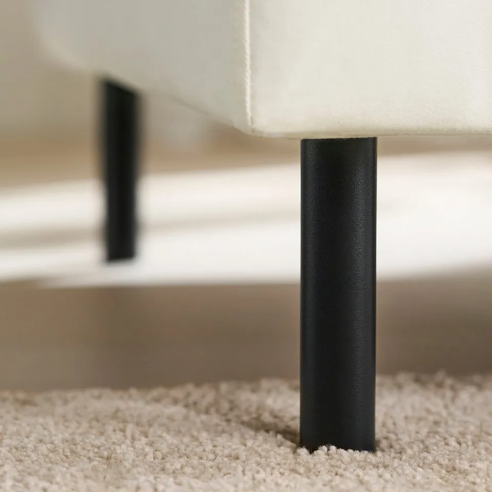 Modern sofa with sleek black legs, offering comfort and support with pocket springs.